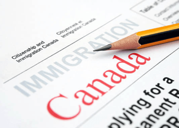 Close-up of a pencil laying on Canadian immigration paperwork..