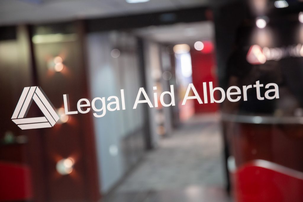 Legal Aid Alberta decal on an office window.