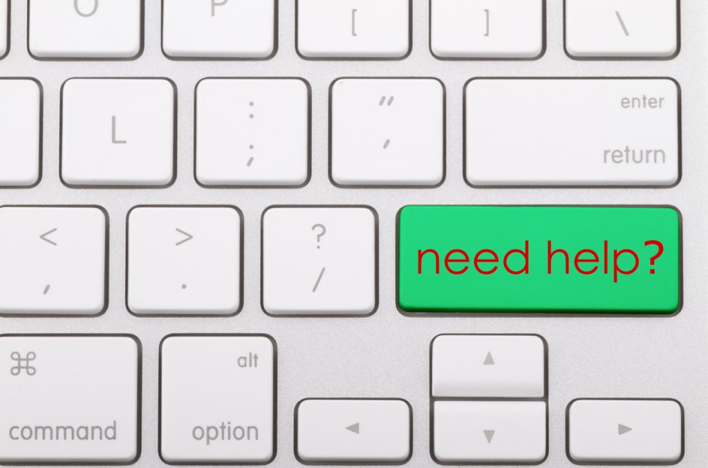 Image of a computer keyboard with a bright green "Need help" key