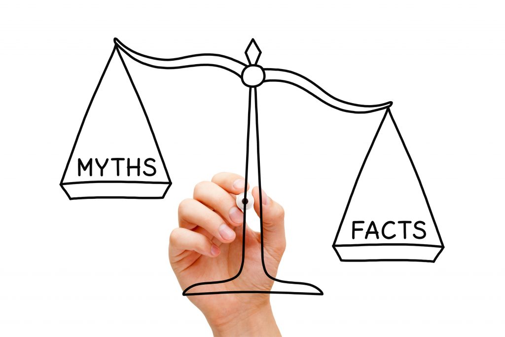 Image of scales of justice balancing the word facts on one side and myths on the other.