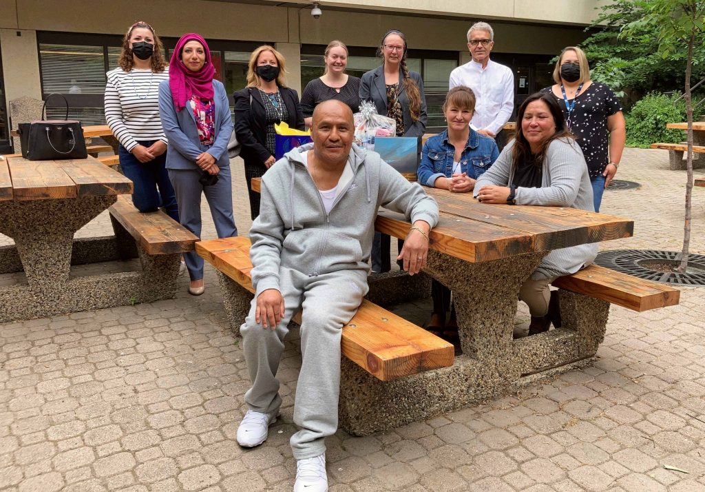 Teh Yellowbird, front centre, with Legal Aid Alberta lawyer Amna Qureshi (second from left) and justice system community supporters.